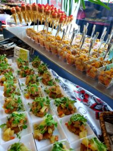 Small bite display of smoked salmon cornets, Louisiana crawfish parfaits & mini jumbo lump crabcakes topped with Tasso hash