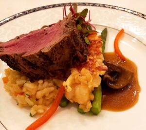 House cut Beef Tenderloin & butter poached Maine Lobster, set on Lobster Risotto & Mushroom demi